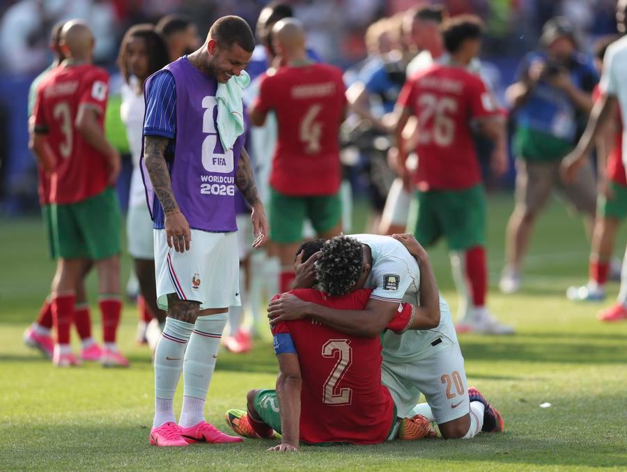 ديزيري دوي (يمين الصورة)، لاعب منتخب فرنسا، يحضن أشرف حكيمي (وسط الصورة)، لاعب منتخب المغرب، عقب مباراة الدور ربع النهائي من بطولة كأس العالم 2026 بين منتخبي فرنسا والمغرب، على استاد بوسطن بمدينة بوسطن في الولايات المتحدة، يوم 9 يوليو 2026. (شينخوا)